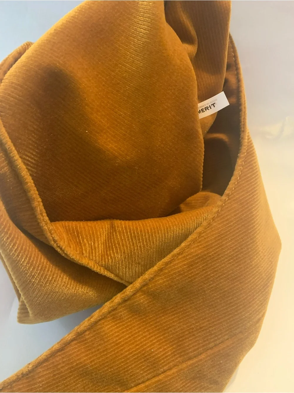 Merit Beauty Signature Bag in a golden brown or camel corduroy material